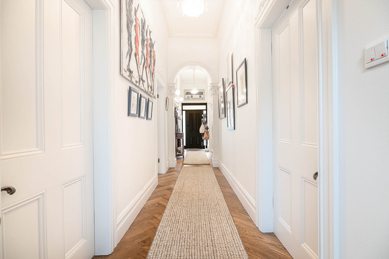 Bright modern hallway in Melbourne home with contemporary artwork and stylish interior design.